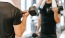 man exercises with dumbell in front of mirror